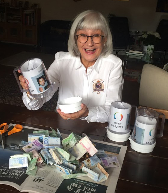 Marianne visar pengarna som hon samlat in till Operation Smile