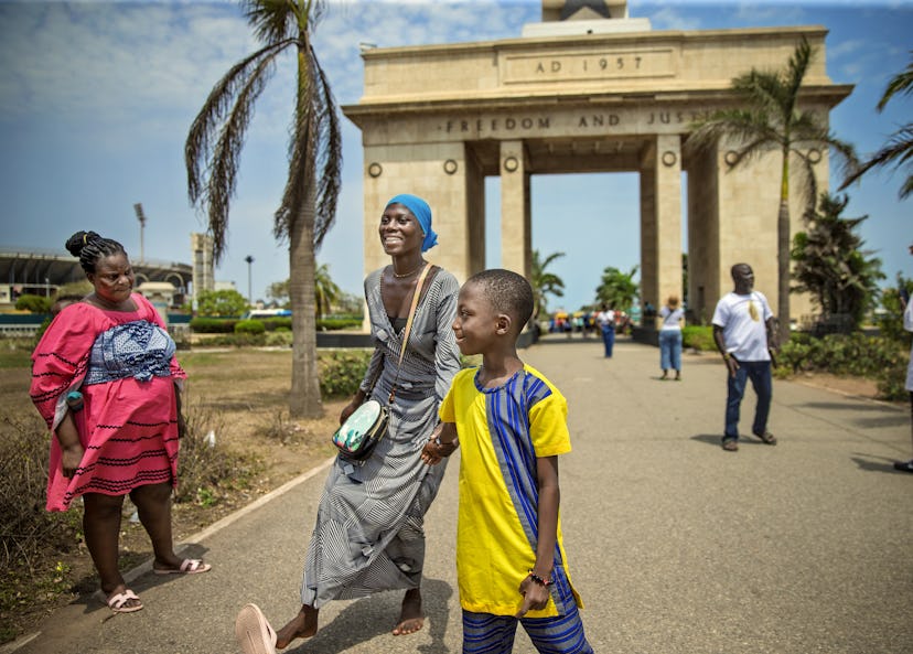 Faizam och Abdul, syster och bror, ser mycket glada ut framför Ghanas självständighetsmonument i Accra.